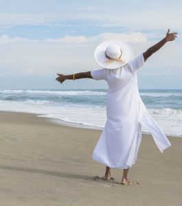 Happy African American Woman Dancing on Beach