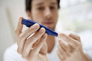 Man Performing Blood Test on Himself