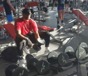 man in gym with weights