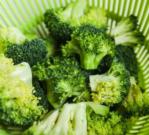 broccoli in a salad strainer basket