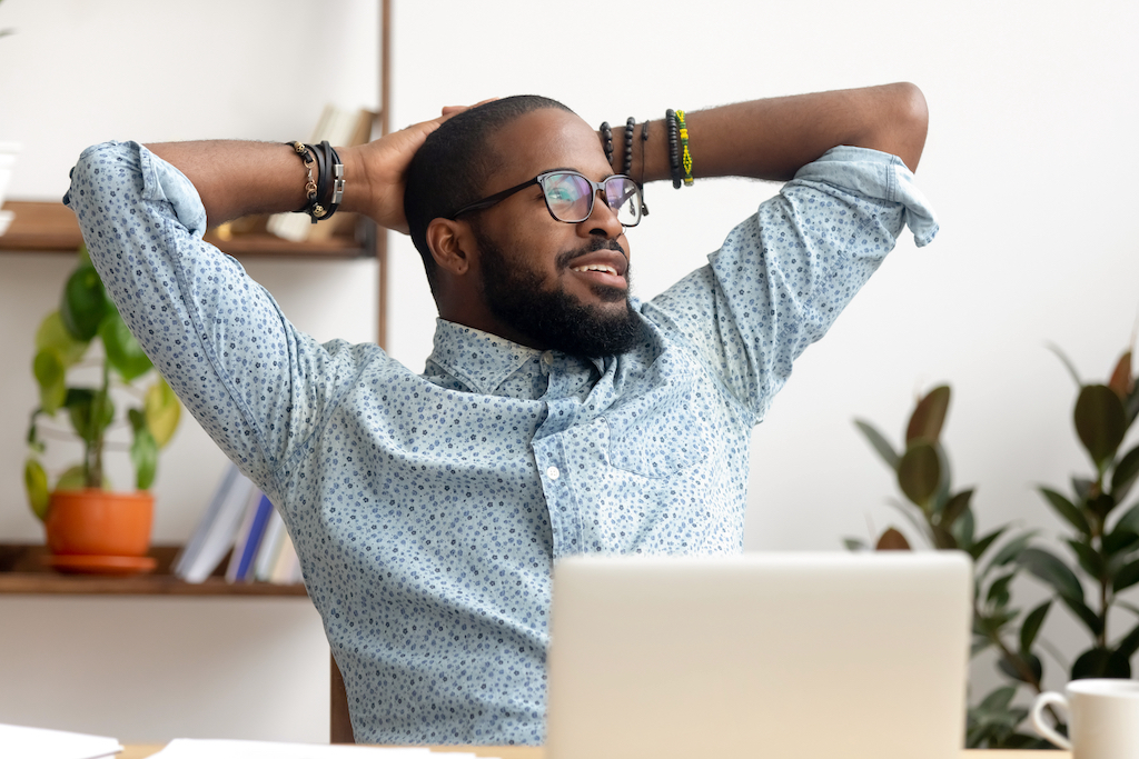 happy black professional employee enjoying a break from the computer and feeling stress relief 