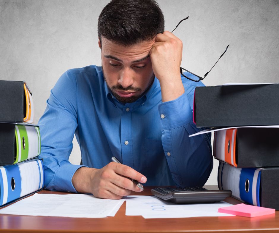 Middle-aged man looking down at task list and feeling overwhelmed. 