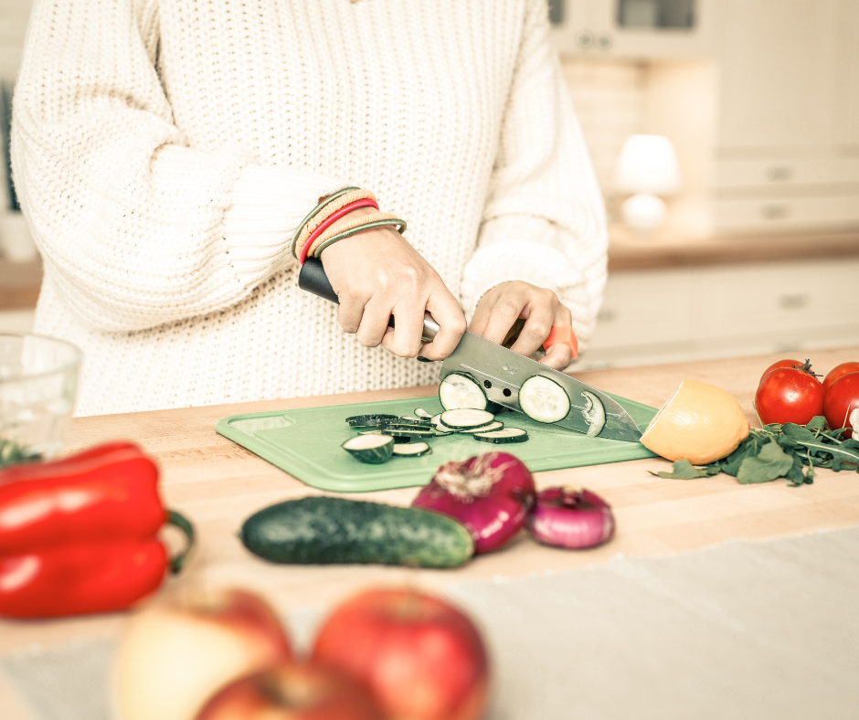 a person is cutting vegetables on a cutting board