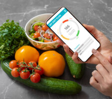 Woman using dieting app to track nutrition facts and calories in her food